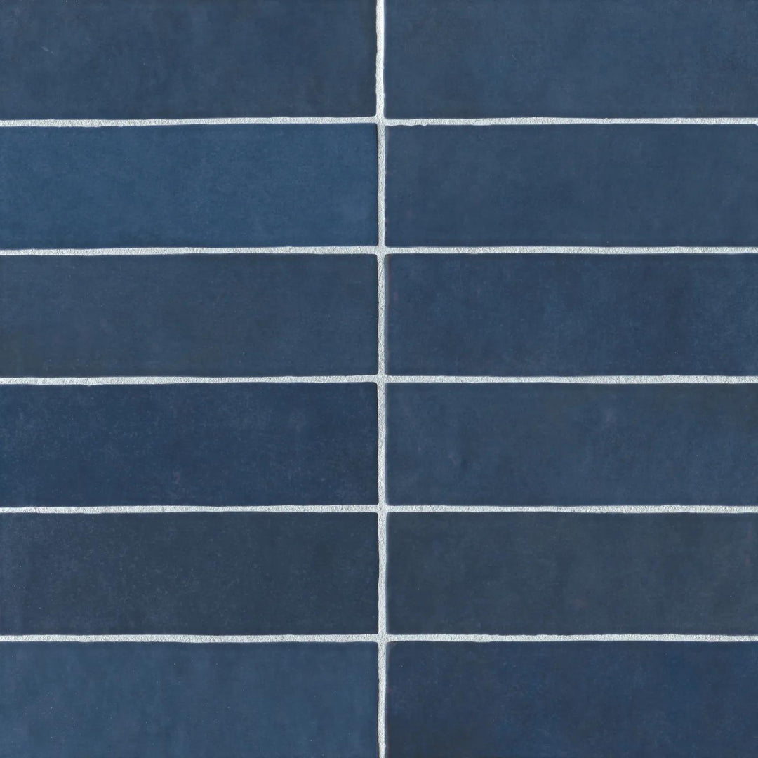 Captured from above, the Cloe Blue 2.5X8 glossy ceramic tile reveals its rich oceanic shade and lustrous glaze, enhancing depth and dimension in any space.