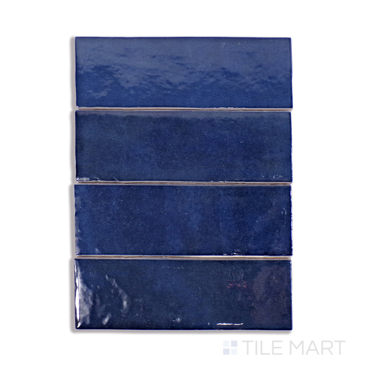 A finely detailed macro shot of Cloe Blue 2.5X8 Gloss Glazed Ceramic tile showcases its rich blue color and glossy glaze, creating a striking and modern appeal.