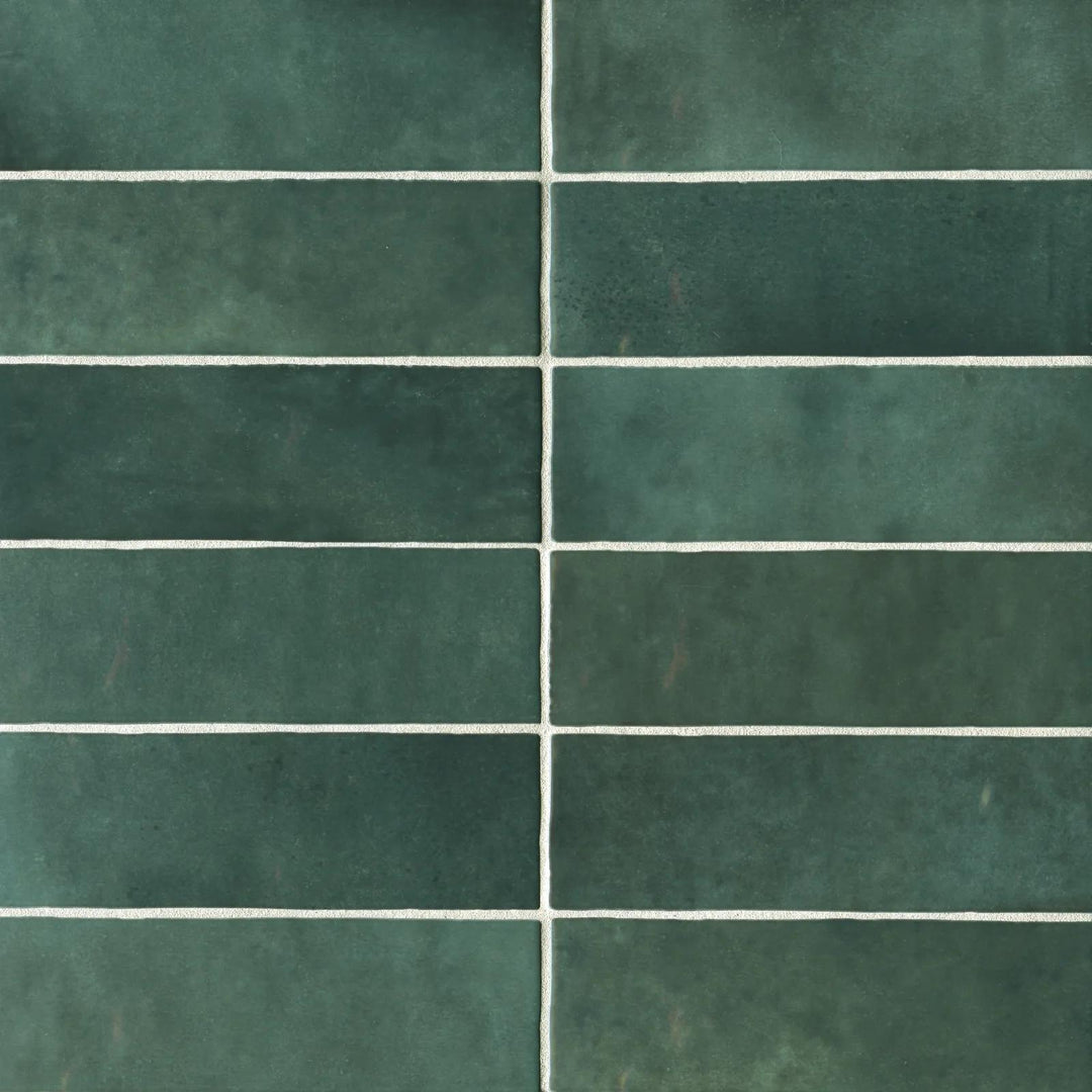 From a top perspective, the Cloe Green 2.5X8 glossy ceramic tile exhibits a refreshing botanical tone with a smooth, glassy surface, perfect for vibrant accents.