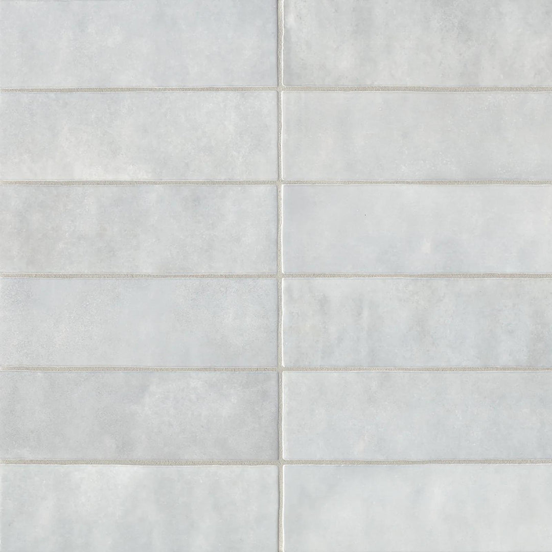 A top-down angle of the Cloe Grey 2.5X8 glossy ceramic tile captures its cool, muted gray and radiant finish, striking the perfect balance between classic and contemporary.
