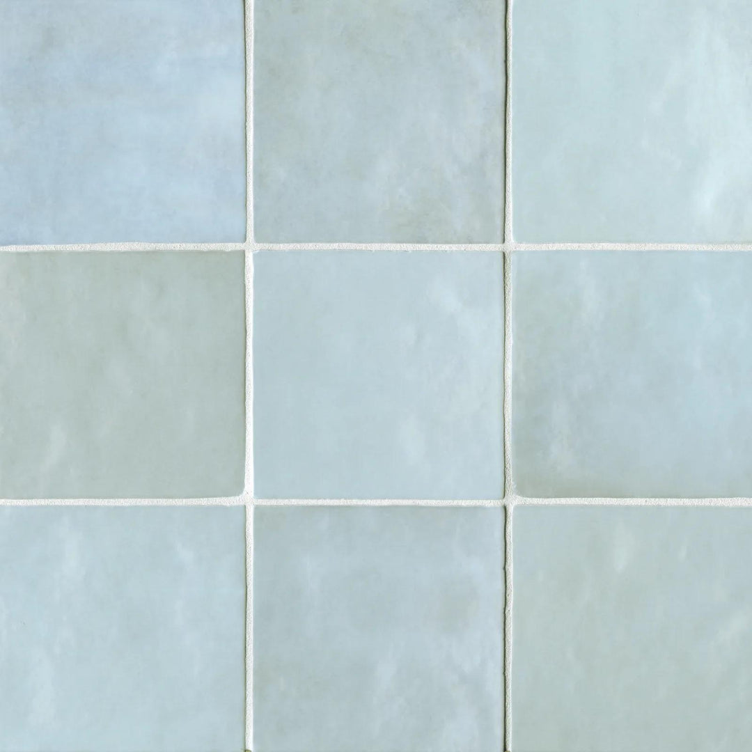 A top-down look at the Cloe Baby Blue 5X5 glossy ceramic tile reveals its gentle pastel hue and mirror-like finish, reflecting light for a fresh and airy aesthetic.