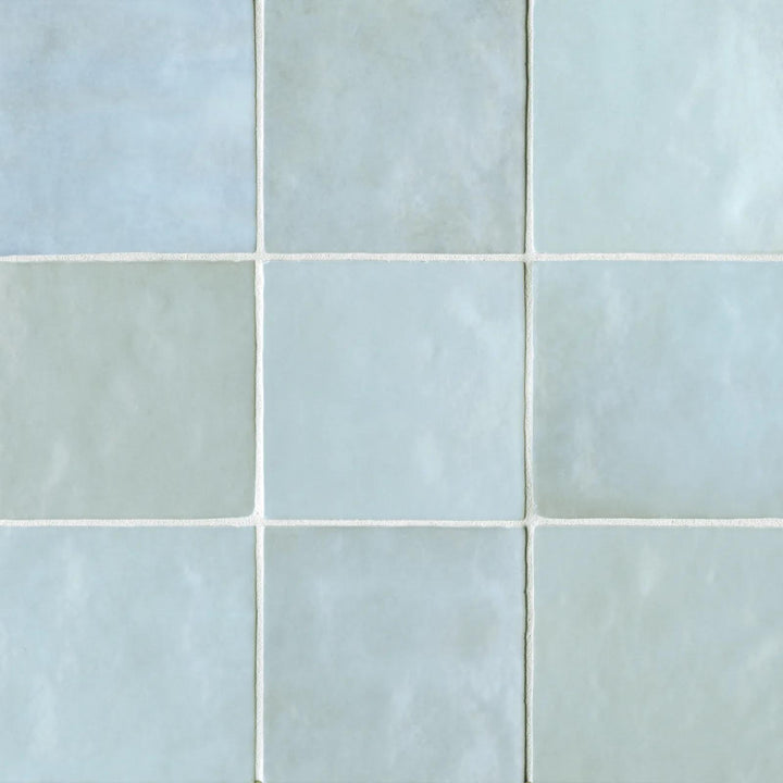 A top-down look at the Cloe Baby Blue 5X5 glossy ceramic tile reveals its gentle pastel hue and mirror-like finish, reflecting light for a fresh and airy aesthetic.
