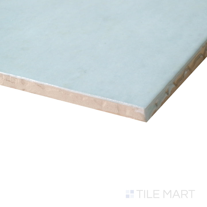 Corner shot of Cloe Baby Blue 5x5 gloss glazed ceramic tile, featuring a soft pastel blue shade, sleek glossy surface, and the clean intersection of its edges.