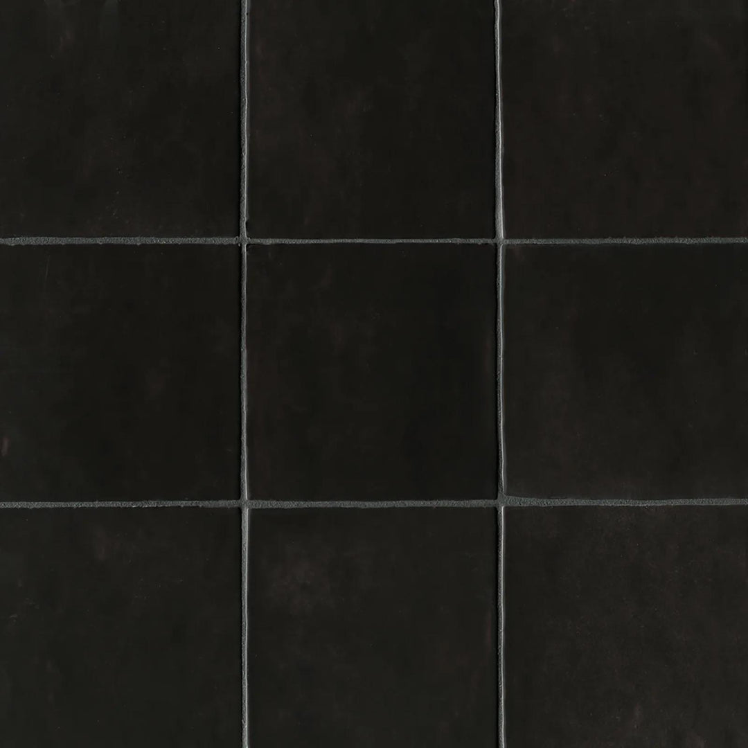 An overhead perspective of the Cloe Black 5X5 glossy ceramic tile showcases its deep black glaze with a sleek shine, adding a bold and modern touch to any space.