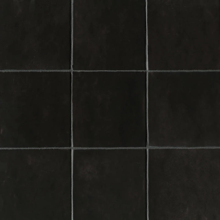 An overhead perspective of the Cloe Black 5X5 glossy ceramic tile showcases its deep black glaze with a sleek shine, adding a bold and modern touch to any space.