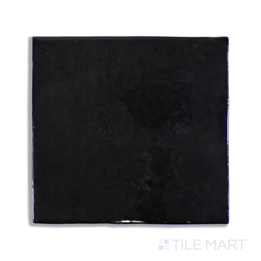 An up-close shot of Cloe Black 5X5 Gloss Glazed Ceramic tile captures its deep black tone and sleek glossy finish, delivering a bold and contemporary feel.