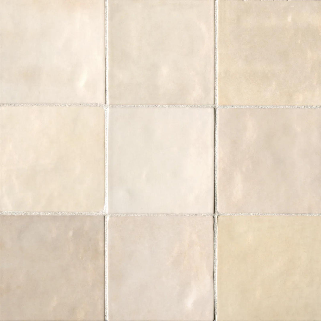 A bird’s-eye view of the Cloe Crème 5X5 glossy ceramic tile highlights its soft beige hue and luminous glaze, creating a warm and inviting atmosphere.