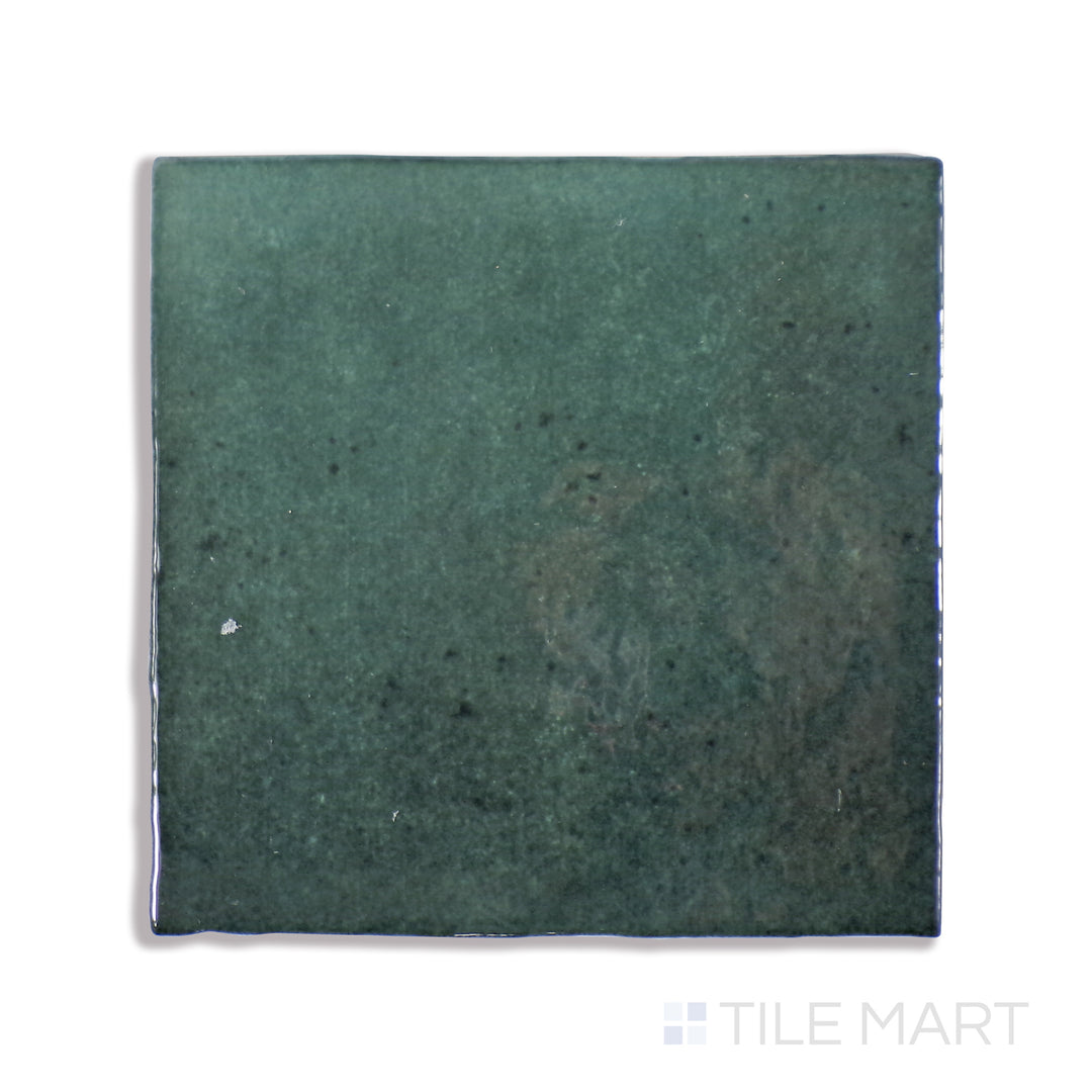 A macro shot of Cloe Green 5X5 Gloss Glazed Ceramic tile showcases its invigorating green tone and glossy sheen, creating a lively and fresh ambiance.