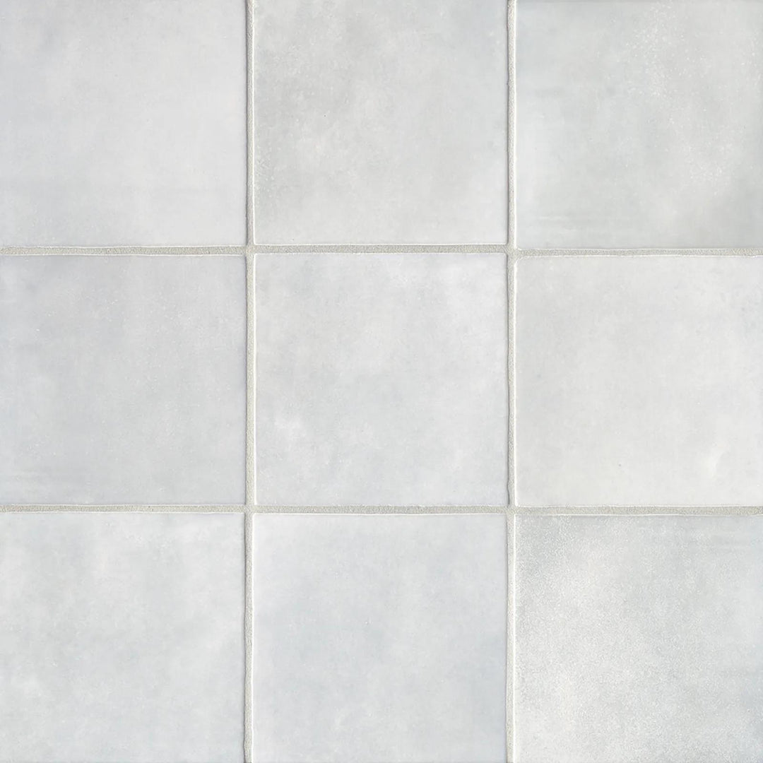 A top-down view of the Cloe Grey 5X5 glossy ceramic tile displays its muted gray shade and glossy texture, perfect for a sleek and versatile aesthetic.