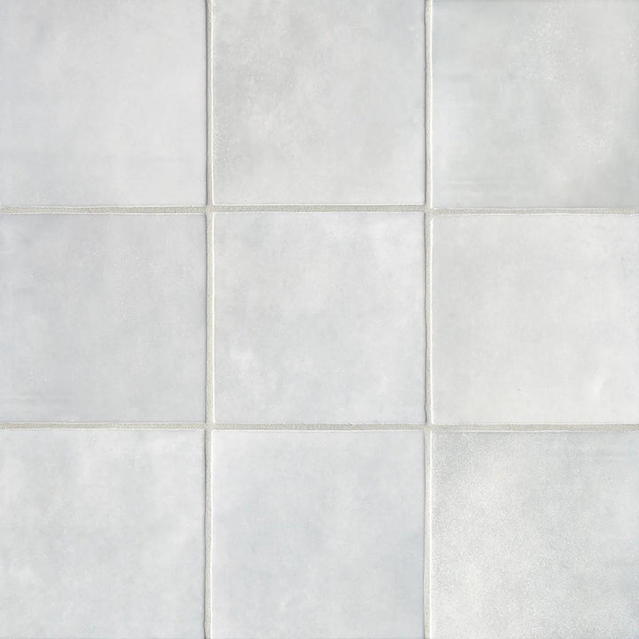 A top-down view of the Cloe Grey 5X5 glossy ceramic tile displays its muted gray shade and glossy texture, perfect for a sleek and versatile aesthetic.