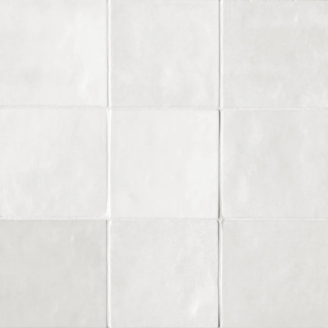A top-down angle of the Cloe White 5X5 glossy ceramic tile captures its pristine white shade and glassy surface, delivering a timeless and luminous appeal.