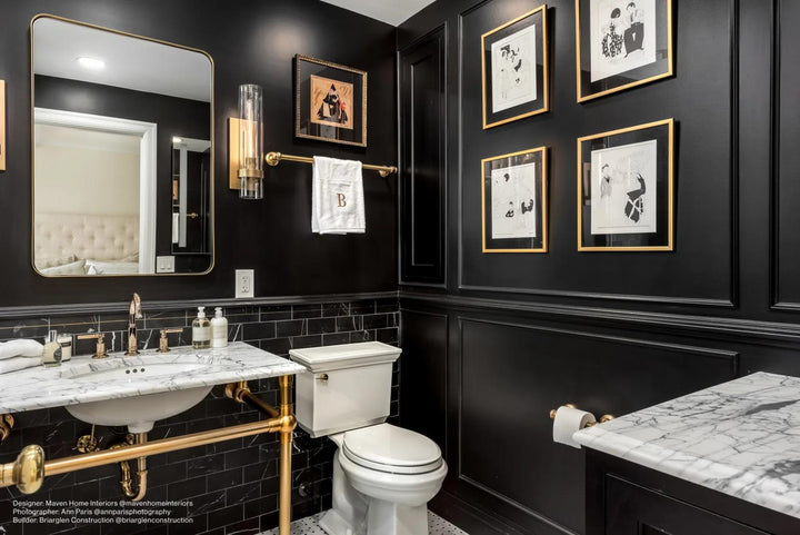 A bold and elegant accent wall featuring Ferrara Nero Deco 3X6 Honed Marble with Brass inlays, combining natural luxury with metallic sophistication.