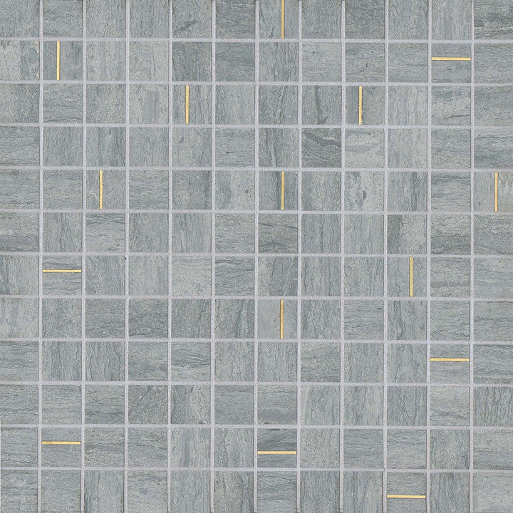 A top-down view of the Ferrara Argento 1" square honed marble mosaic reveals a sleek gray stone surface, elegantly punctuated with brass inlays for a refined, geometric aesthetic.