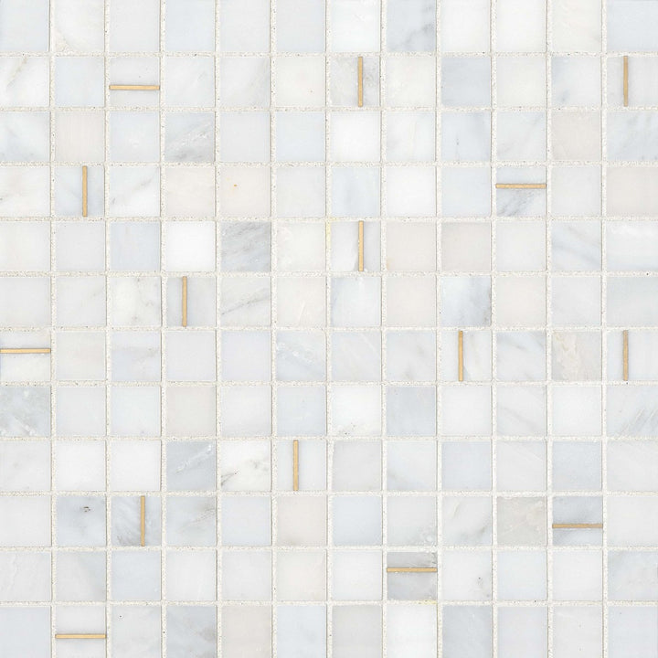 An overhead look at the Ferrara Bianco 1" square honed marble mosaic showcases its bright white background, beautifully contrasted with fine brass accents for a modern, timeless appeal.