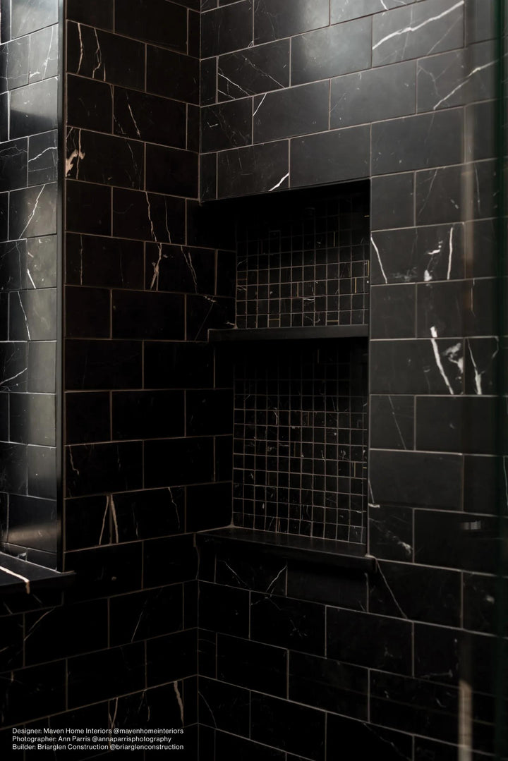 An artistic mosaic statement made with Ferrara Nero 1" Square Honed Marble, Brass Mosaic, perfect for adding depth and character to any surface.
