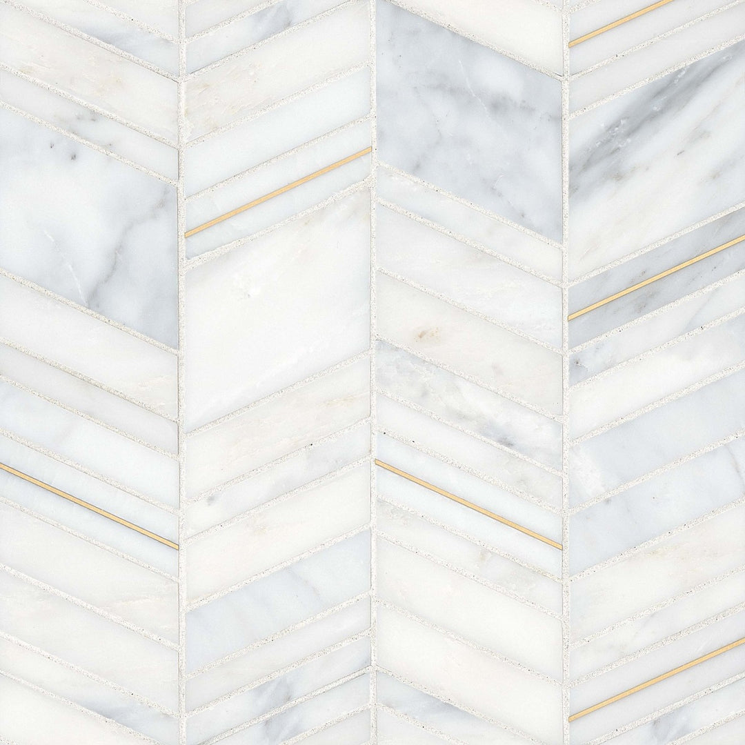 An overhead shot of the Ferrara Bianco Chevron honed marble mosaic displays crisp white marble, stylishly arranged in a chevron layout with shimmering brass accents for added dimension.