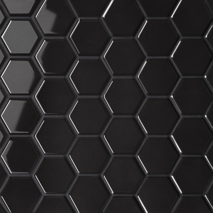 From a top-down perspective, the Le Café Black 2" Hexagon Gloss Porcelain Mosaic showcases a glossy jet-black finish, highlighting its structured geometry with a sleek, reflective sheen.