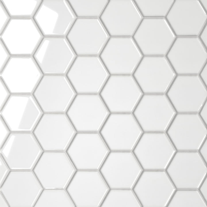 An aerial view of the Le Café White 2" Hexagon Gloss Porcelain Mosaic reveals a luminous, polished white finish, enhancing the hexagonal pattern with a bright and airy aesthetic.
