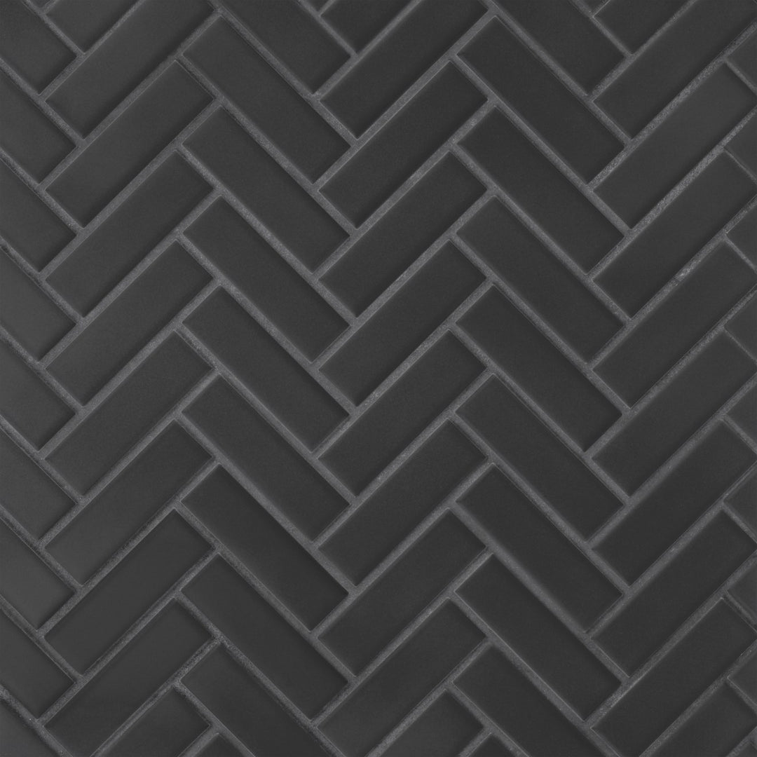 From a bird’s-eye view, the Le Café Black Herringbone Matte Porcelain Mosaic presents an intricate zigzag pattern in a rich matte black, adding dynamic movement and classic elegance to any space.