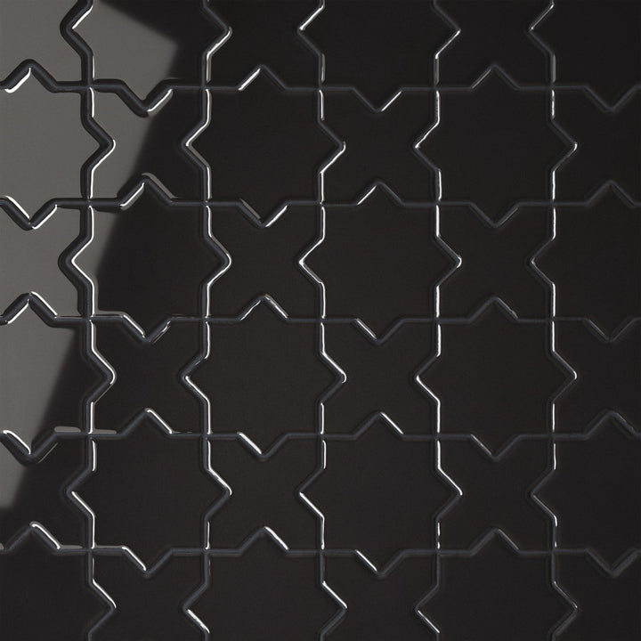 This top-down shot of the Le Café Black Cross & Star Gloss Porcelain Mosaic emphasizes a glossy black surface that enhances the intricate star-and-cross motif, delivering a refined and luxurious look.