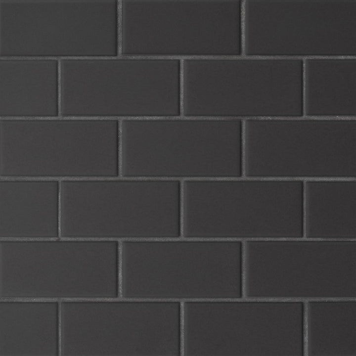 Aerial imagery of the Le Café Black Offset Matte Porcelain Mosaic reveals a staggered layout in a deep matte black, providing depth and movement to any surface with a contemporary edge.