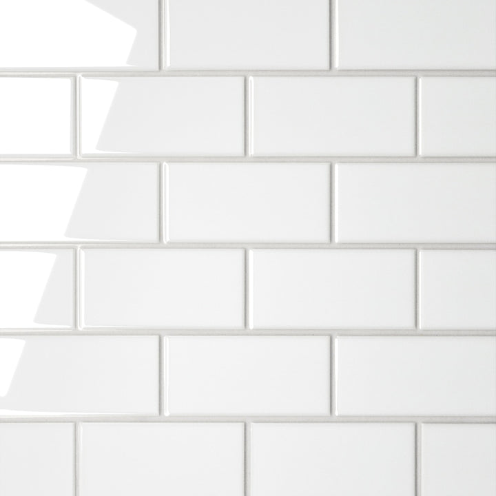 A direct top-down shot of the Le Café White Offset Gloss Porcelain Mosaic showcases a high-gloss white finish in an offset pattern, brightening spaces with its sleek, staggered elegance.