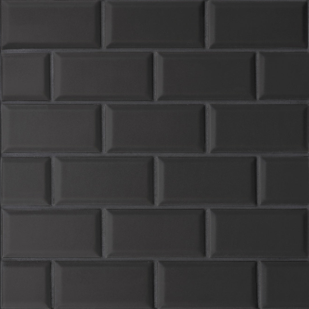 A top-down perspective of the Le Café Black Bevel Offset matte mosaic showcases its structured beveling and deep black hue, creating a sophisticated, dimensional surface.