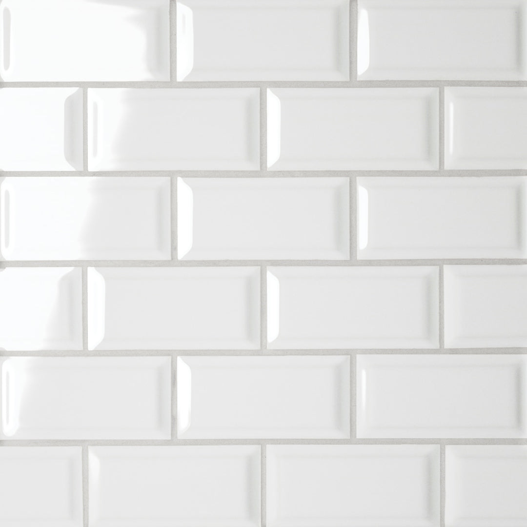 From a top-down angle, the Le Café White Bevel Offset glossy mosaic gleams with its pristine white finish, creating a bright and polished aesthetic with striking depth.