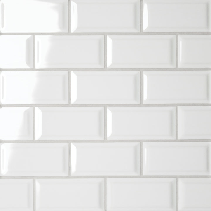 From a top-down angle, the Le Café White Bevel Offset glossy mosaic gleams with its pristine white finish, creating a bright and polished aesthetic with striking depth.