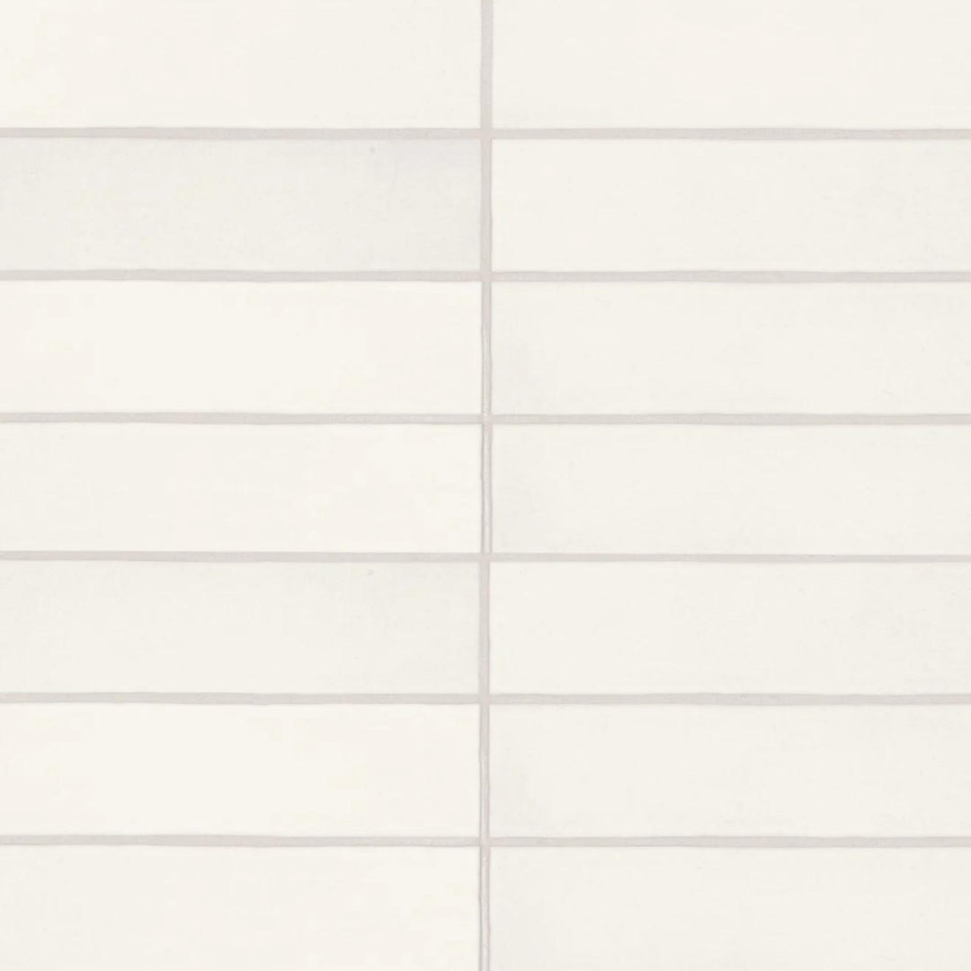 An overhead view of the Makoto Shoji White 2.5X10 matte ceramic tile showcases its soft white surface, offering a minimalist yet warm aesthetic with a handcrafted feel.