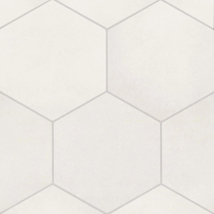 A top-down view of the Makoto Shoji White 10" hex matte porcelain tile captures its crisp white tone and geometric elegance, creating a refined and airy visual effect.