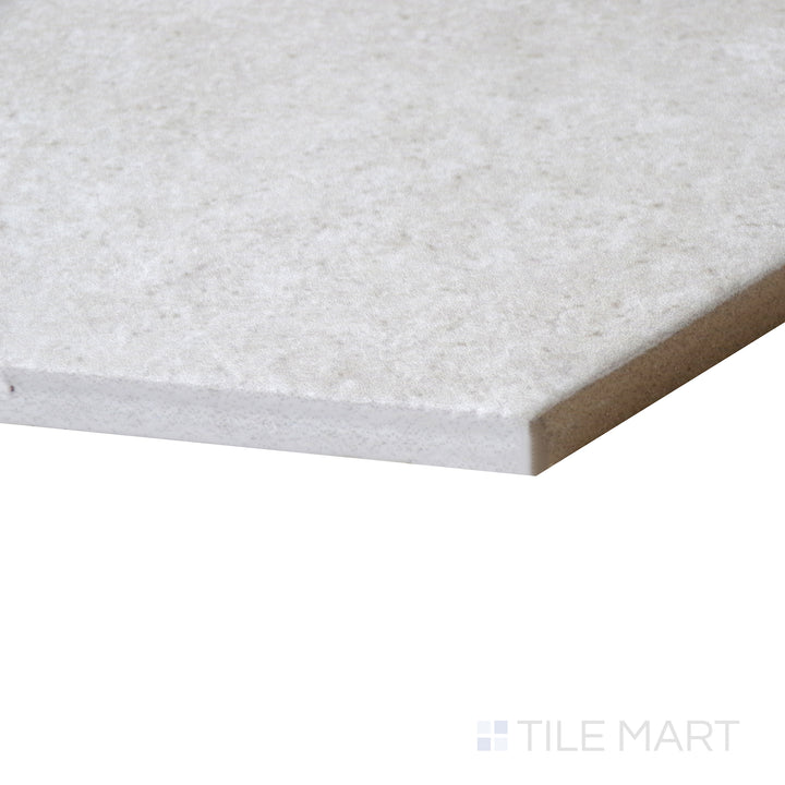 Angled close-up of Makoto Kumo Grey 10" hex matte porcelain tile, showcasing its soft grey finish, sharp hexagonal edges, and smooth matte surface.