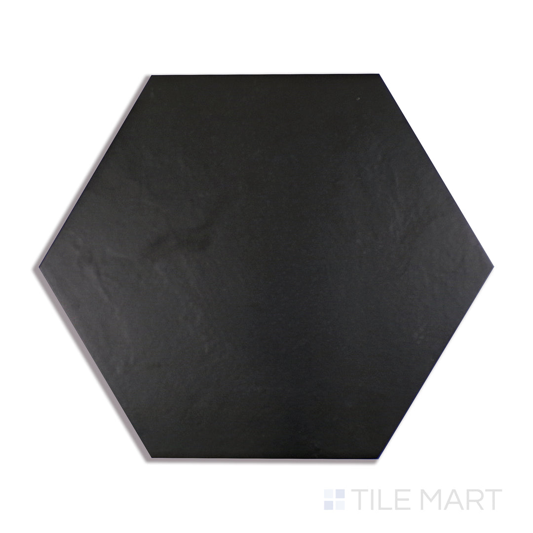 A close-up shot of Makoto Kuroi Black 10" Hex Matte Porcelain tile emphasizes its deep black shade and structured hexagon design, adding bold contrast to any space.