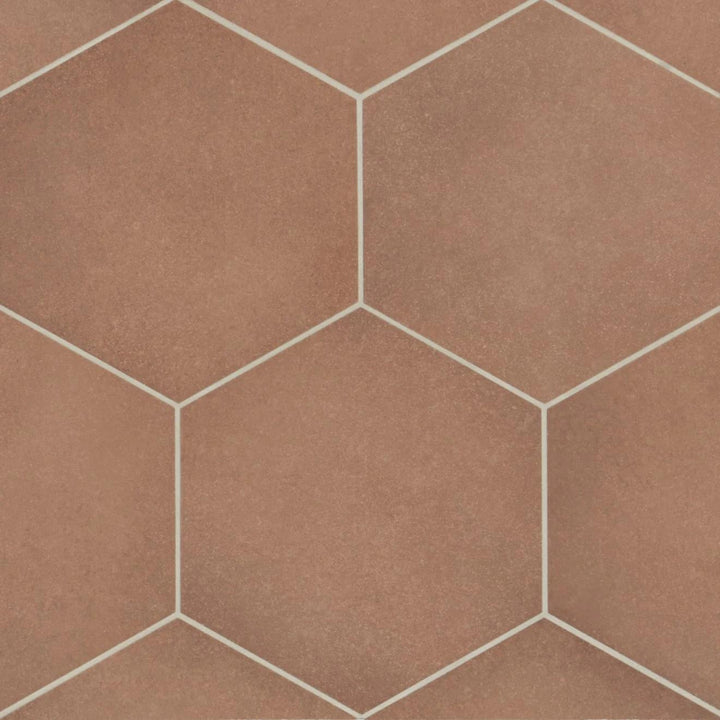 A top-down view of the Makoto Umi Terracotta 10" hex matte porcelain tile highlights its rich, earthy terracotta shade, blending rustic warmth with geometric precision.