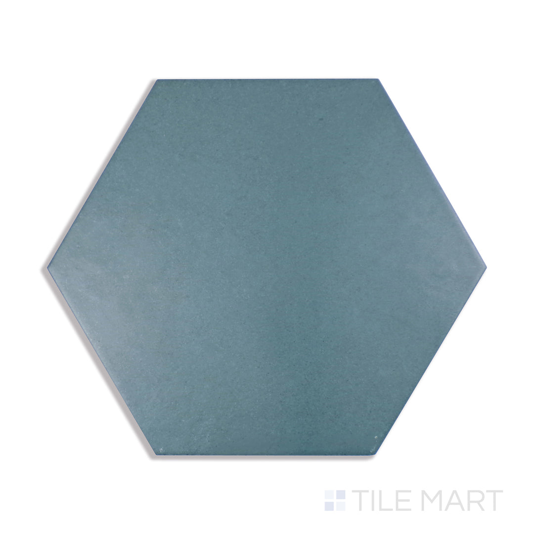 A detailed close-up of Makoto Arashi Blue 10" Hex Matte Porcelain tile highlights its deep blue color and matte surface, adding a touch of contemporary elegance.