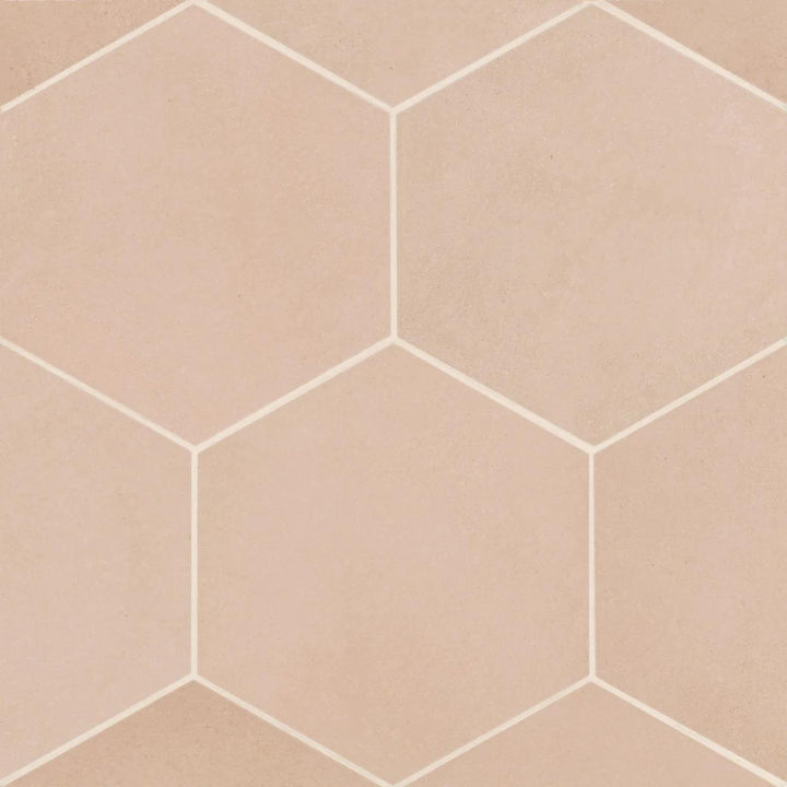 An aerial perspective of the Makoto Momoiro Blush 10" Hex Matte Porcelain showcases its delicate blush pink shade, offering a soft, contemporary touch with a refined hexagonal layout.