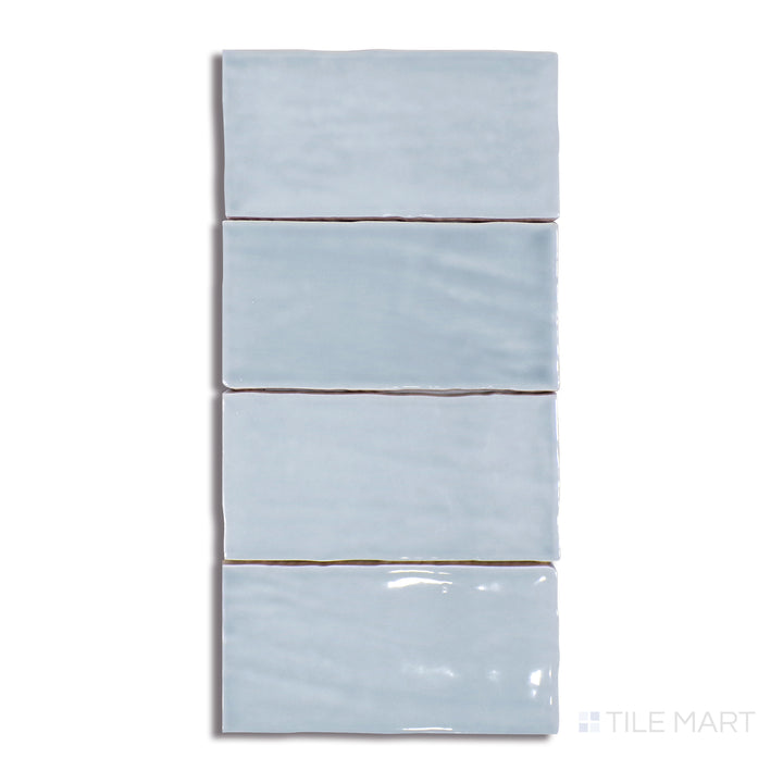 A highly detailed close-up of Marin Misty Blue 2.5X5 Gloss Glazed Ceramic tile emphasizes its soft blue-grey undertones and high-gloss finish, ideal for a tranquil aesthetic.