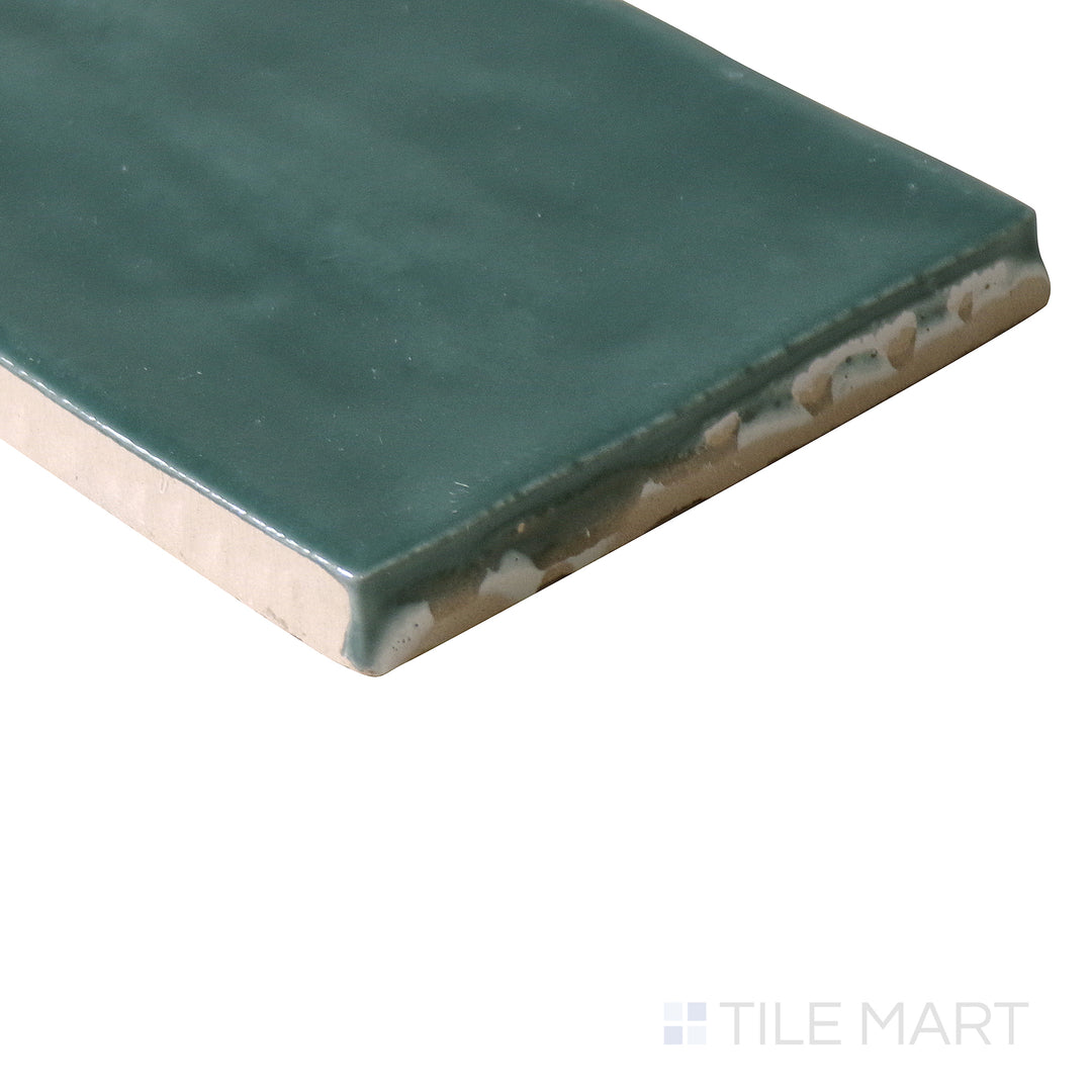 Corner shot of Marin Ocean Teal 2.5x5 gloss glazed ceramic tile, capturing its vibrant teal hue, smooth glazed surface, and the clean transition at the edges.
