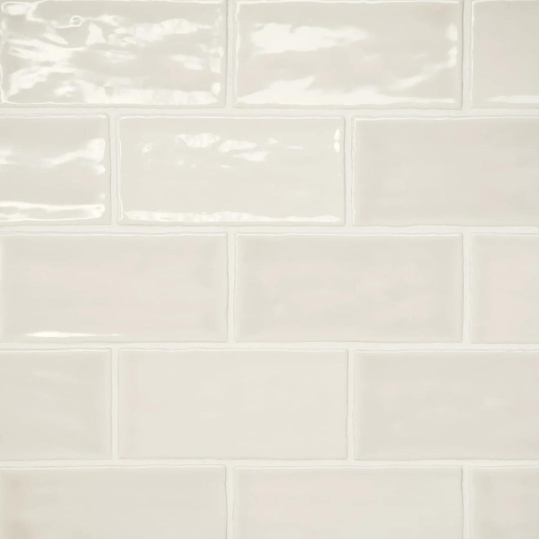 An aerial display of the Marin Sand Dollar 2.5X5 Gloss Glazed Ceramic unveils its warm beige hue, capturing the essence of sun-kissed coastal sands with a gleaming finish.