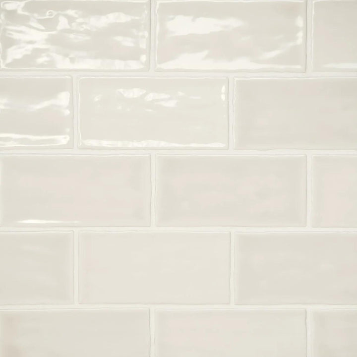 An aerial display of the Marin Sand Dollar 2.5X5 Gloss Glazed Ceramic unveils its warm beige hue, capturing the essence of sun-kissed coastal sands with a gleaming finish.