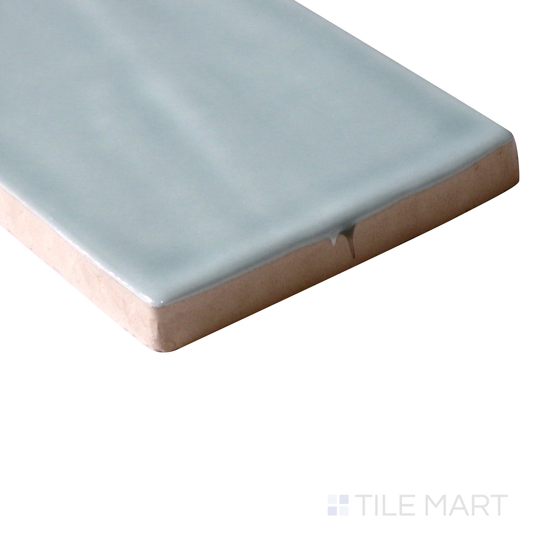 Corner shot of Marin Aloe Green 2.5x10 gloss glazed ceramic tile, showcasing its light green color, glossy surface, and precisely crafted edge detailing.