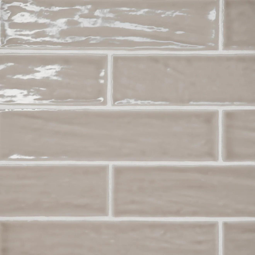 An overhead view of the Marin Coastal Cliff 2.5X10 Gloss Glazed Ceramic mirrors the rugged beauty of coastal landscapes, featuring a cool stone-inspired shade with a glistening finish.