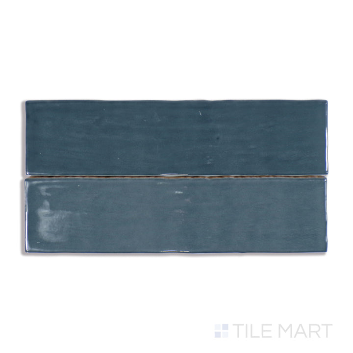 A finely detailed close-up of Marin Midnight Tide 2.5X10 Gloss Glazed Ceramic tile showcases its deep navy blue shade and luminous glaze, perfect for elegant interior designs.