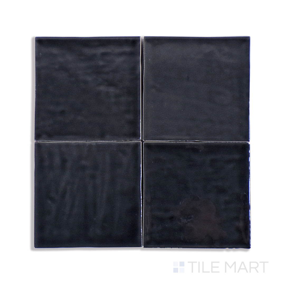 An up-close view of Marin Black Sea 4X4 Gloss Glazed Ceramic tile emphasizes its inky black tone and high-gloss finish, creating a dramatic statement piece.
