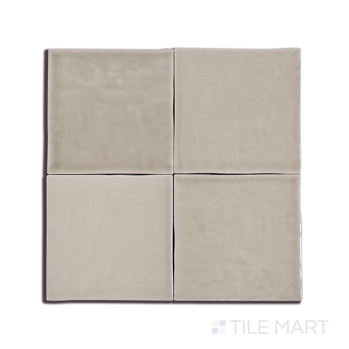 A crisp close-up of Marin Coastal Cliff 4X4 Gloss Glazed Ceramic tile accentuates its warm neutral shade and sleek glaze, seamlessly complementing modern interiors.
