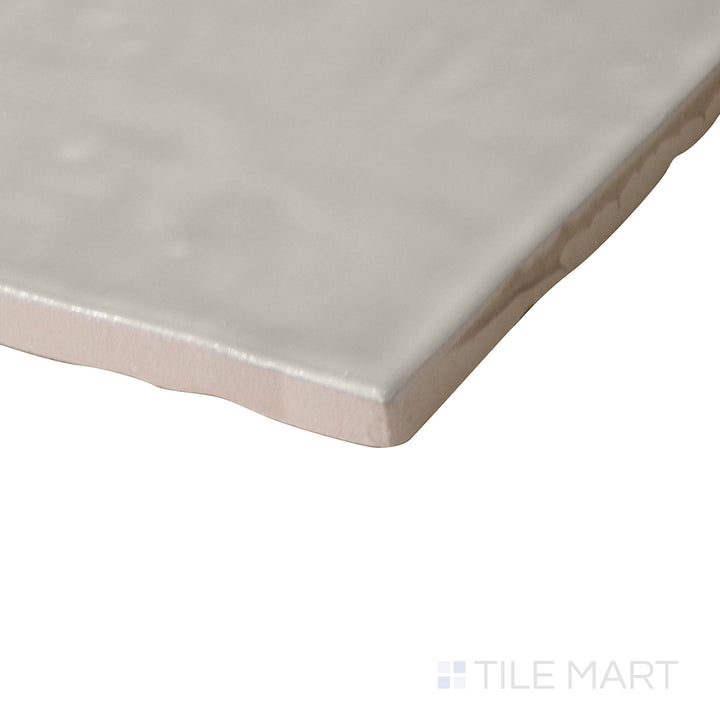 Angled perspective of Marin Coastal Cliff 4x4 gloss glazed ceramic tile, showcasing its soft neutral tone, polished surface, and crisp corner transition.