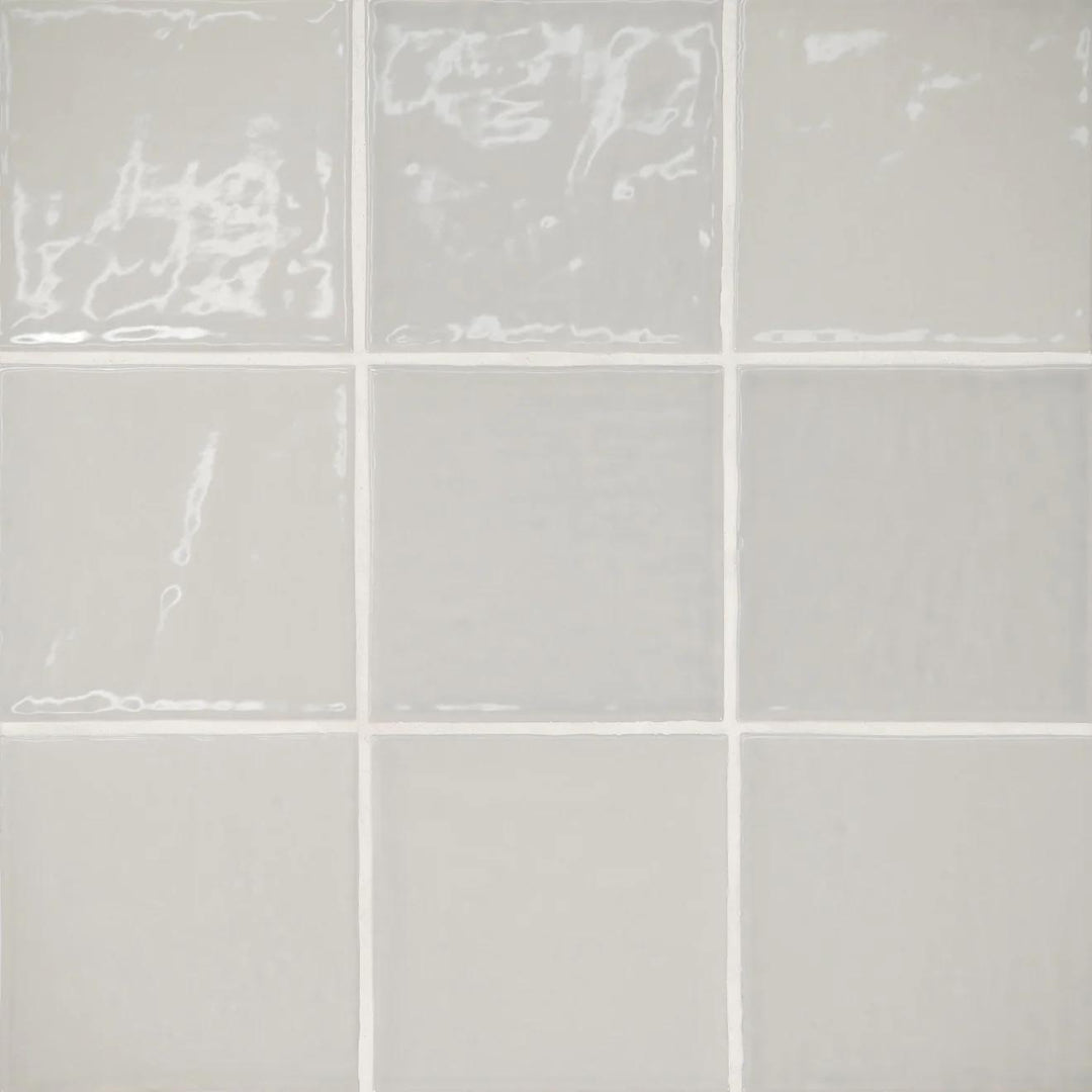 A seamless top-down view of the Marin Pebble Gray 4X4 Gloss Glazed Ceramic reveals its subtle gray undertones, softened by a high-gloss finish.