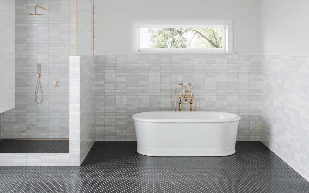 Soft veining and crisp white hues define Monet White Carrara 2x8 honed marble, elevating any space with a refined and graceful ambiance.