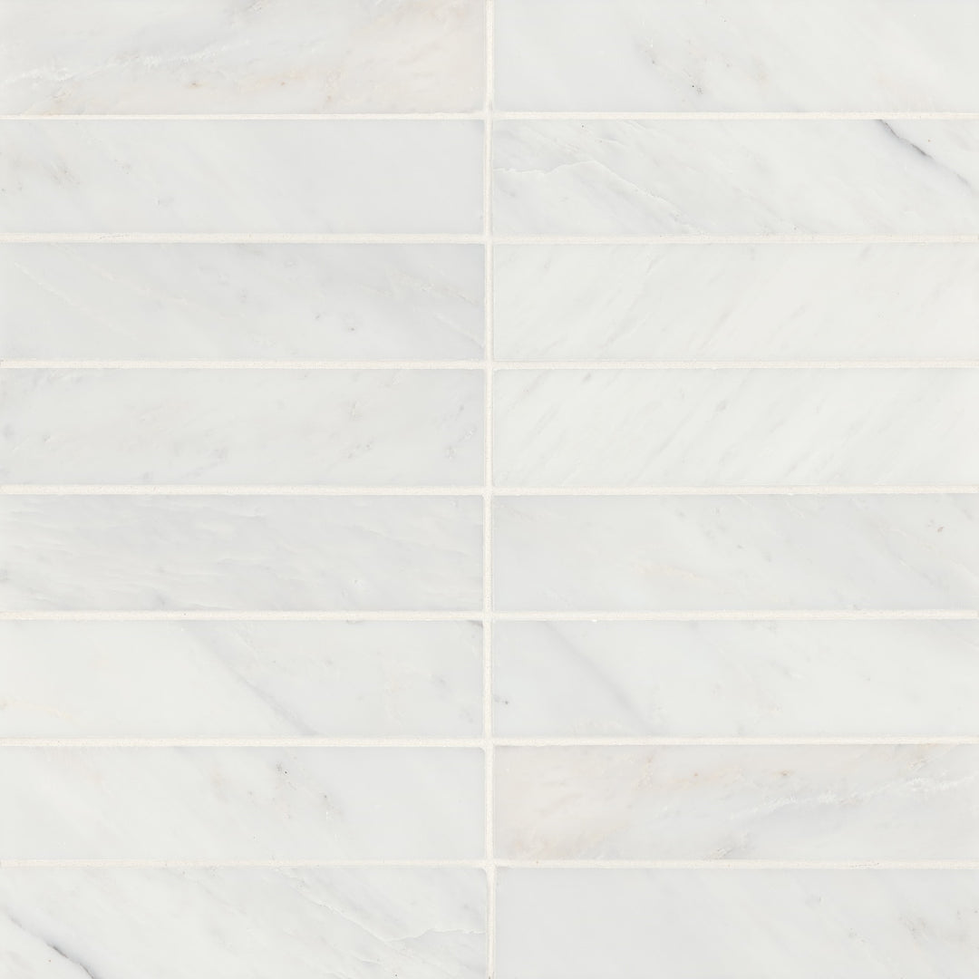 Aerial imagery of Monet Oriental White 2X8 Honed Marble reveals a pristine white surface with subtle gray veining, offering a fresh and sophisticated ambiance.