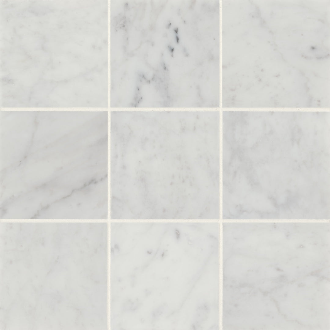 A seamless flat-lay of Monet White Carrara 4X4 Honed Marble brings out its refined texture and soft color variations, ideal for classic and modern designs.